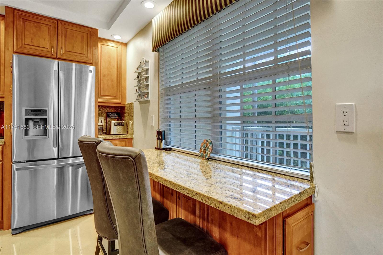 3520 Oaks Way, Unit 308 Pompano Beach, FL 33069 - Photo 2 of 40 a kitchen with stainless steel appliances granite countertop a refrigerator a sink and a stove