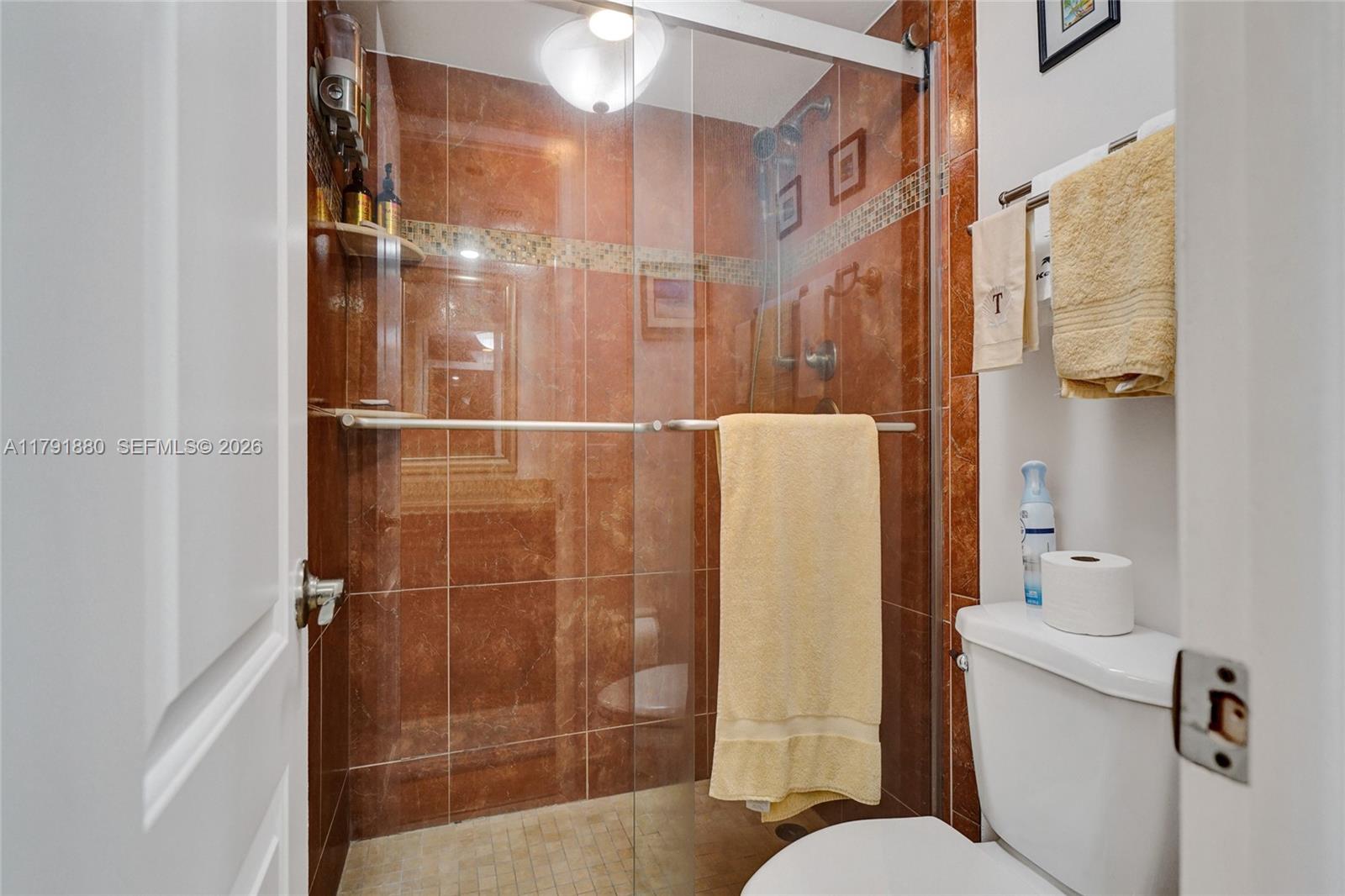 3520 Oaks Way, Unit 308 Pompano Beach, FL 33069 - Photo 24 of 40 a bathroom with a shower and toilet