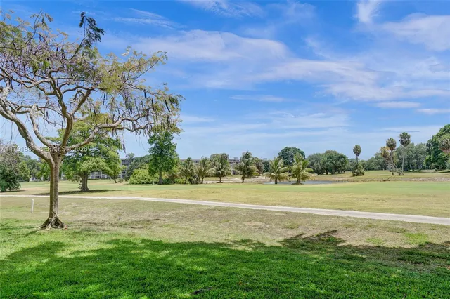 a view of a swimming pool with a patio and a garden