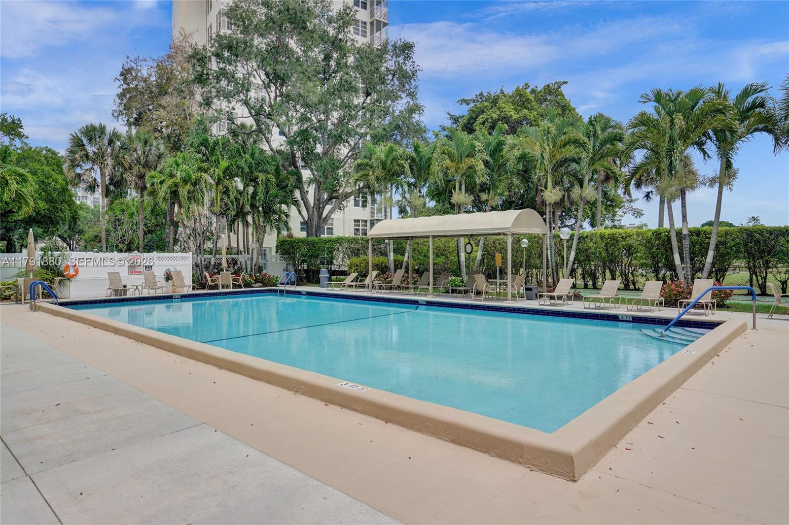3520 Oaks Way, Unit 308 Pompano Beach, FL 33069 - Photo 32 of 40 swimming pool view with a seating space