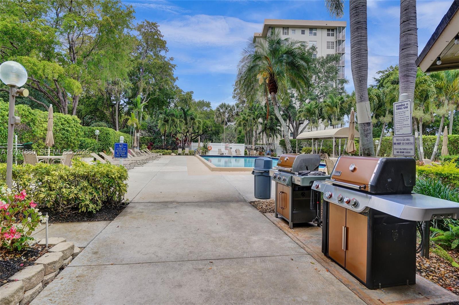 3520 Oaks Way, Unit 308 Pompano Beach, FL 33069 - Photo 34 of 40 a view of a backyard with sitting area