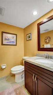 a bathroom with a sink a toilet and mirror