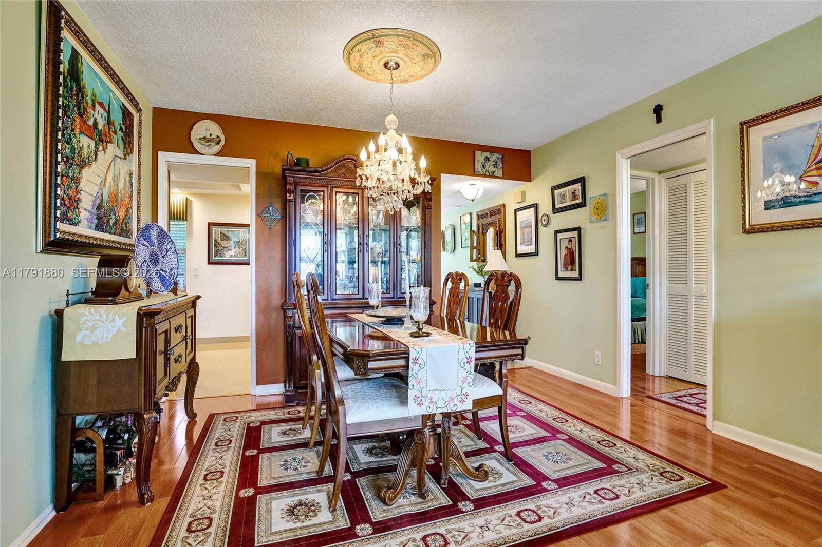 3520 Oaks Way, Unit 308 Pompano Beach, FL 33069 - Photo 7 of 40 a living room with furniture a rug and a chandelier