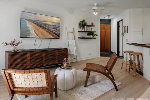 a living room with furniture and wooden floor