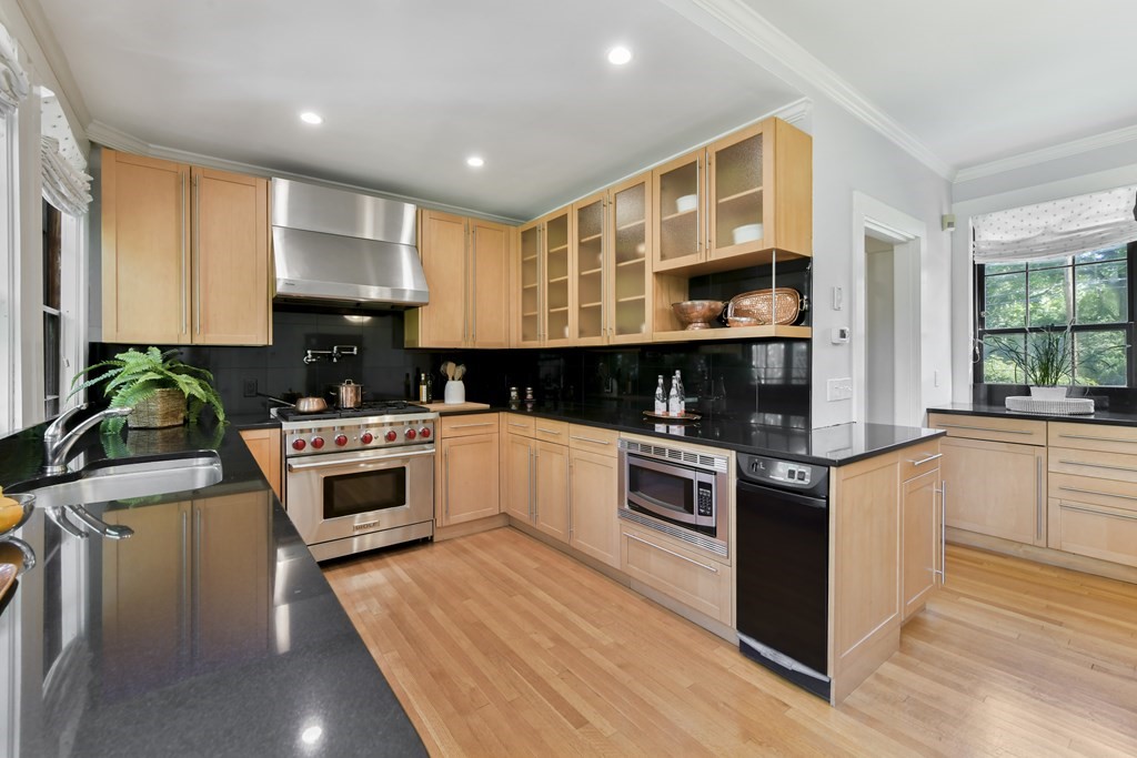 4 Berkeley Street Cambridge, MA 02138 - Photo 13 of 28 a kitchen with granite countertop a stove a sink and a refrigerator