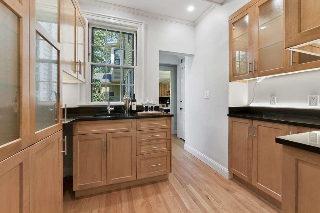 4 Berkeley Street Cambridge, MA 02138 - Photo 14 of 28 a kitchen with stainless steel appliances granite countertop a sink a stove and a refrigerator