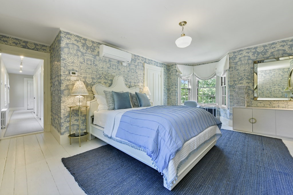 4 Berkeley Street Cambridge, MA 02138 - Photo 17 of 28 a spacious bedroom with a bed and wooden floor