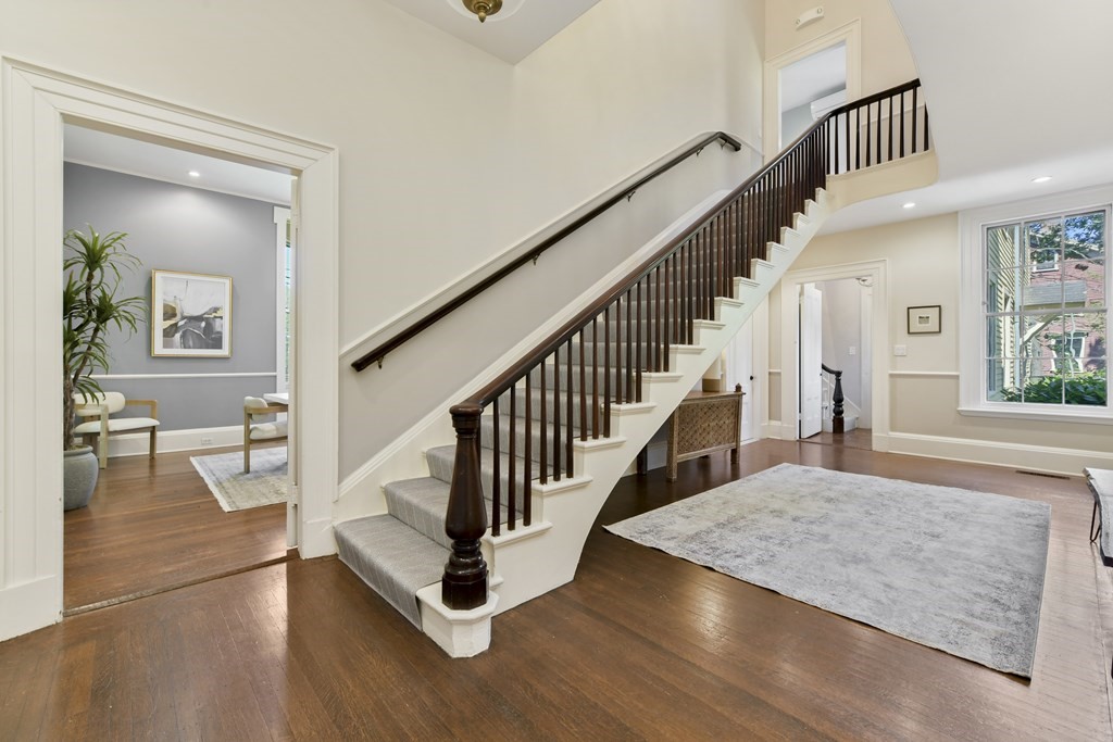 4 Berkeley Street Cambridge, MA 02138 - Photo 2 of 28 a view of staircase with lots of frames on wall and wooden floor