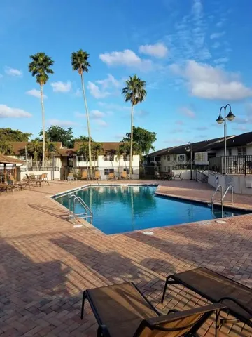 a view of swimming pool with outdoor seating