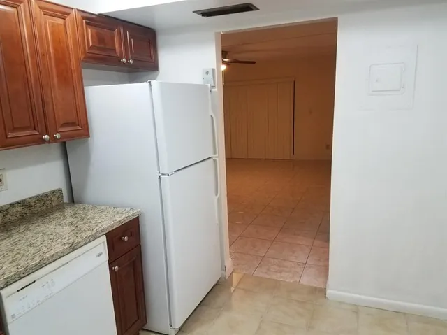 a kitchen with a refrigerator and a sink
