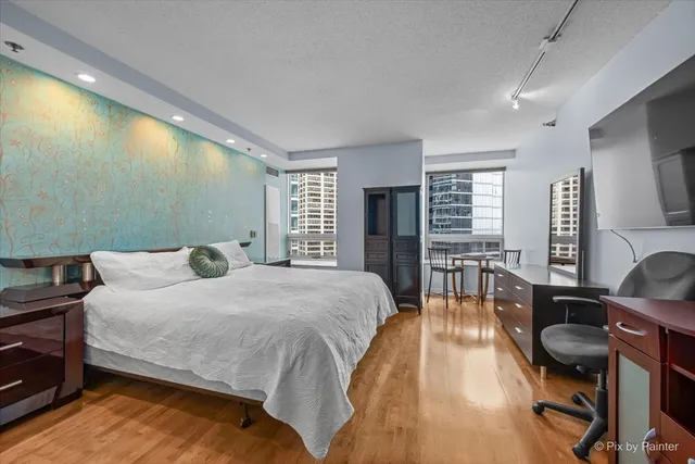 a bedroom with a bed and wooden floor