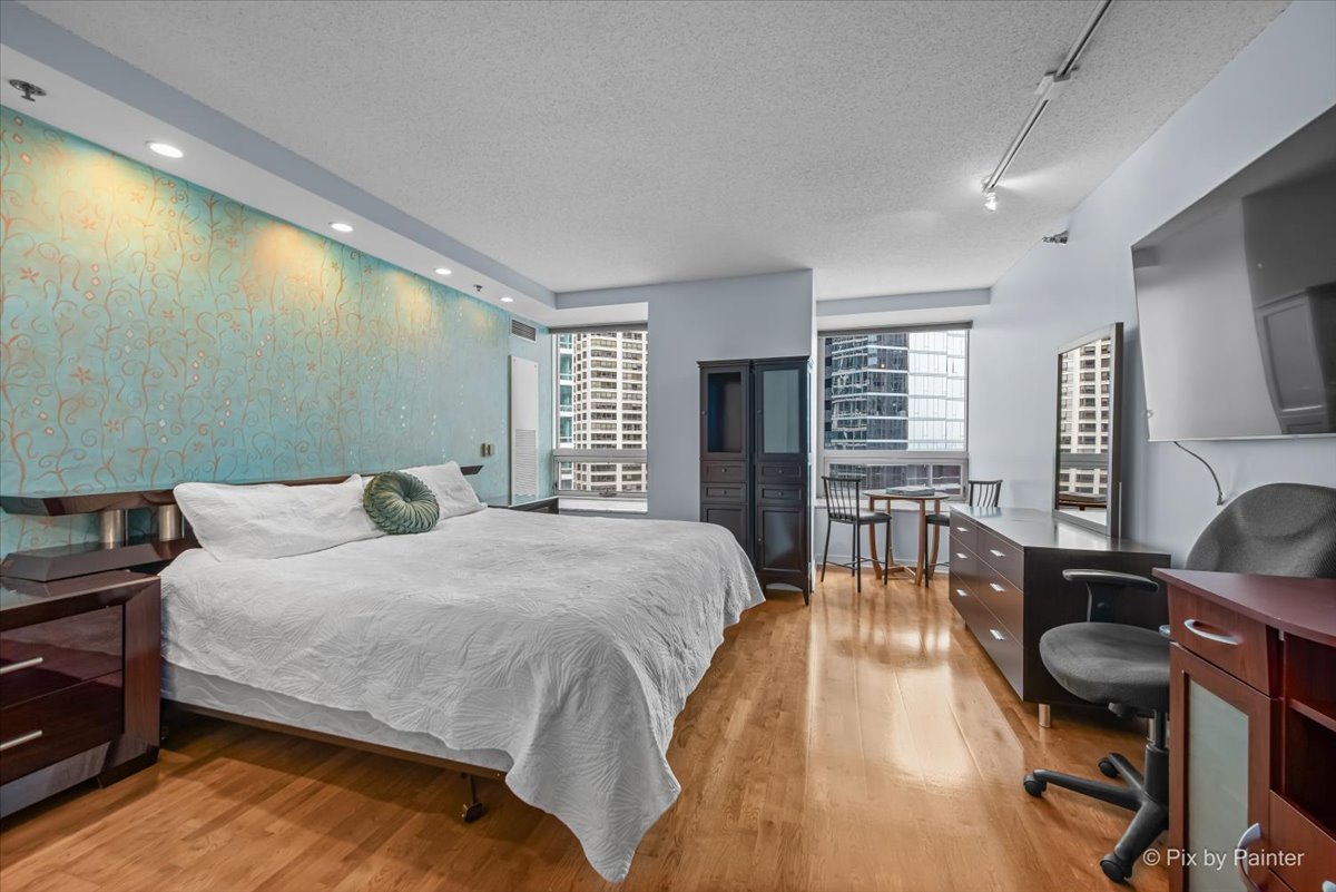 512 North McClurg Court, Unit 501 Chicago, IL 60611 - Photo 15 of 40 a bedroom with a bed and wooden floor