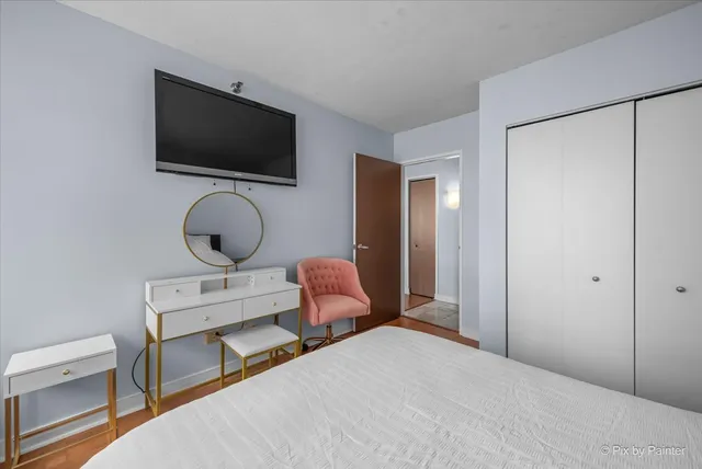 a bedroom with a bed and a flat screen tv