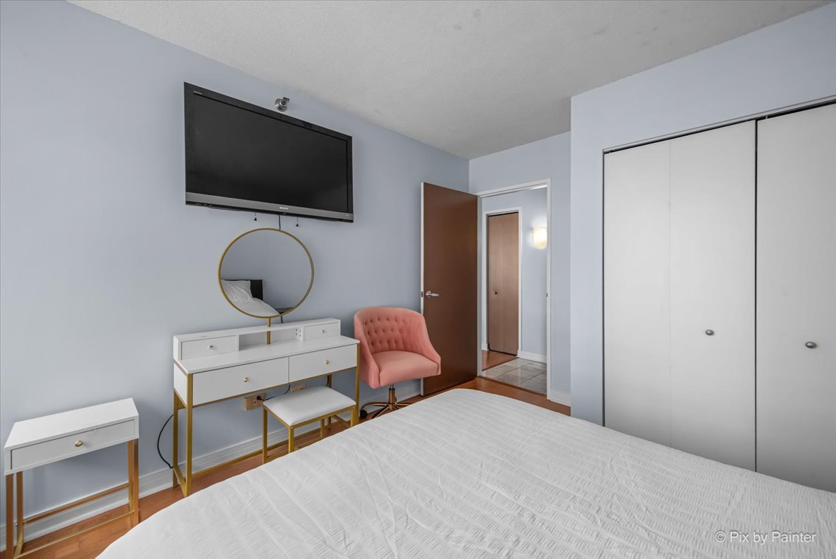 512 North McClurg Court, Unit 501 Chicago, IL 60611 - Photo 20 of 40 a bedroom with a bed and a flat screen tv