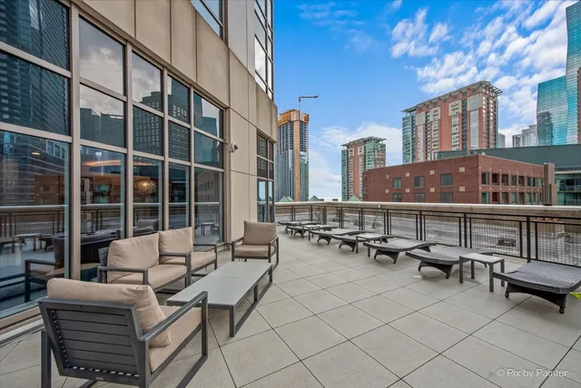 a view of balcony with chairs and a potted plant
