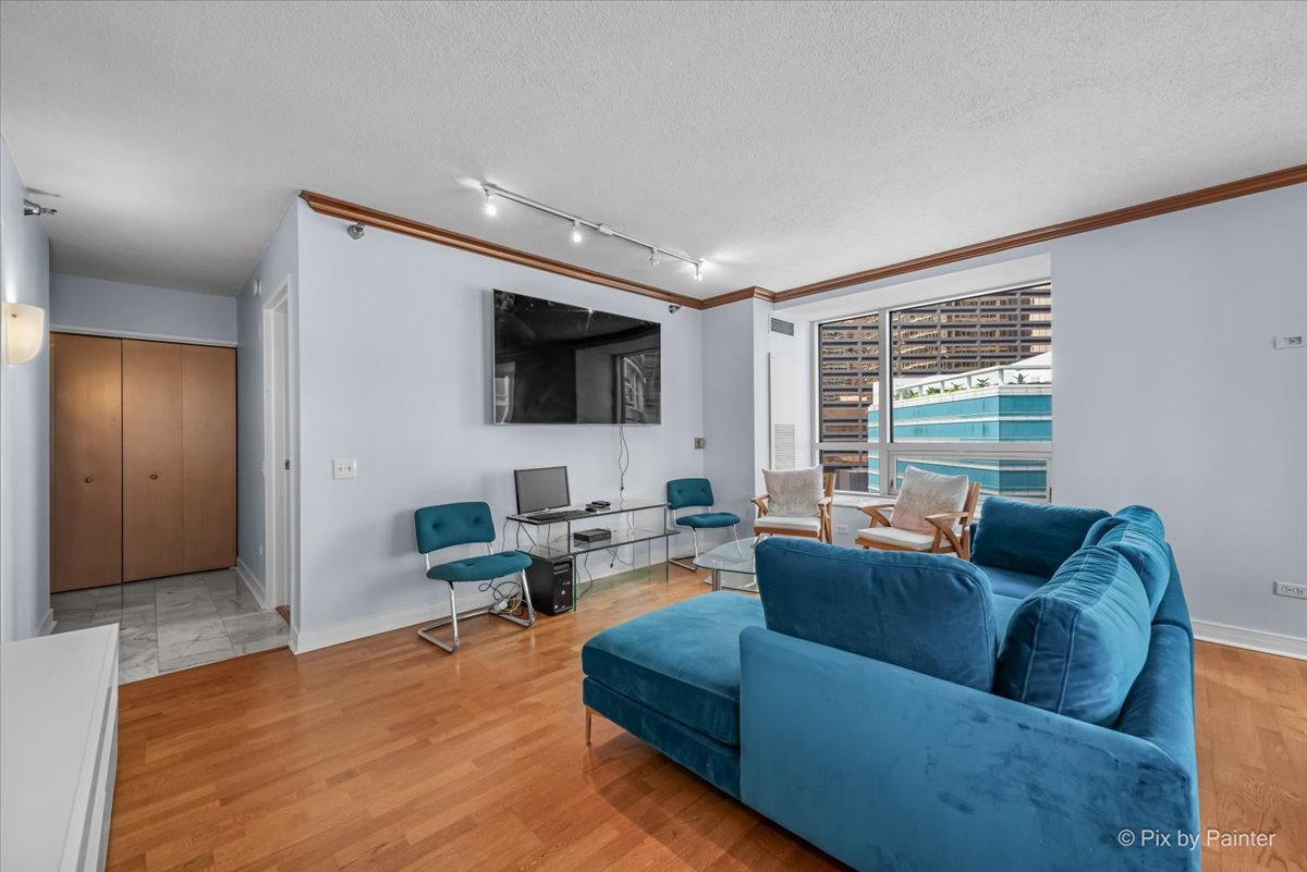 512 North McClurg Court, Unit 501 Chicago, IL 60611 - Photo 6 of 40 a living room with furniture and a flat screen tv
