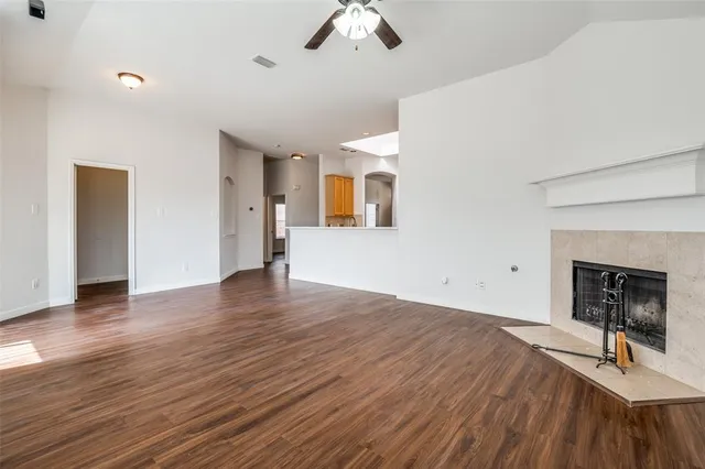 a view of a livingroom with wooden floor and a ceiling fan