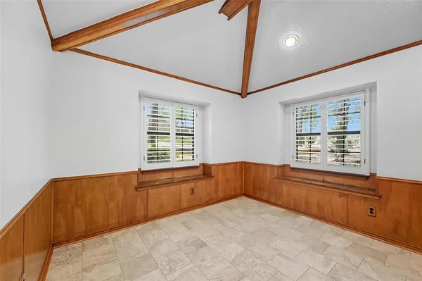 a spacious bedroom with a large bed and a window