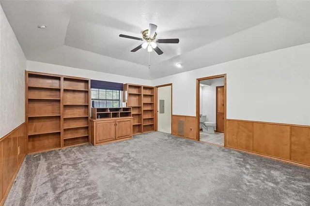a living room with closet and ceiling fan