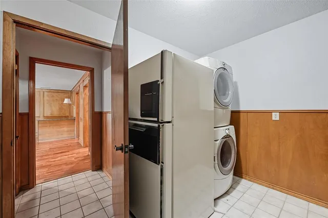 a view of a hallway with wooden cabinets