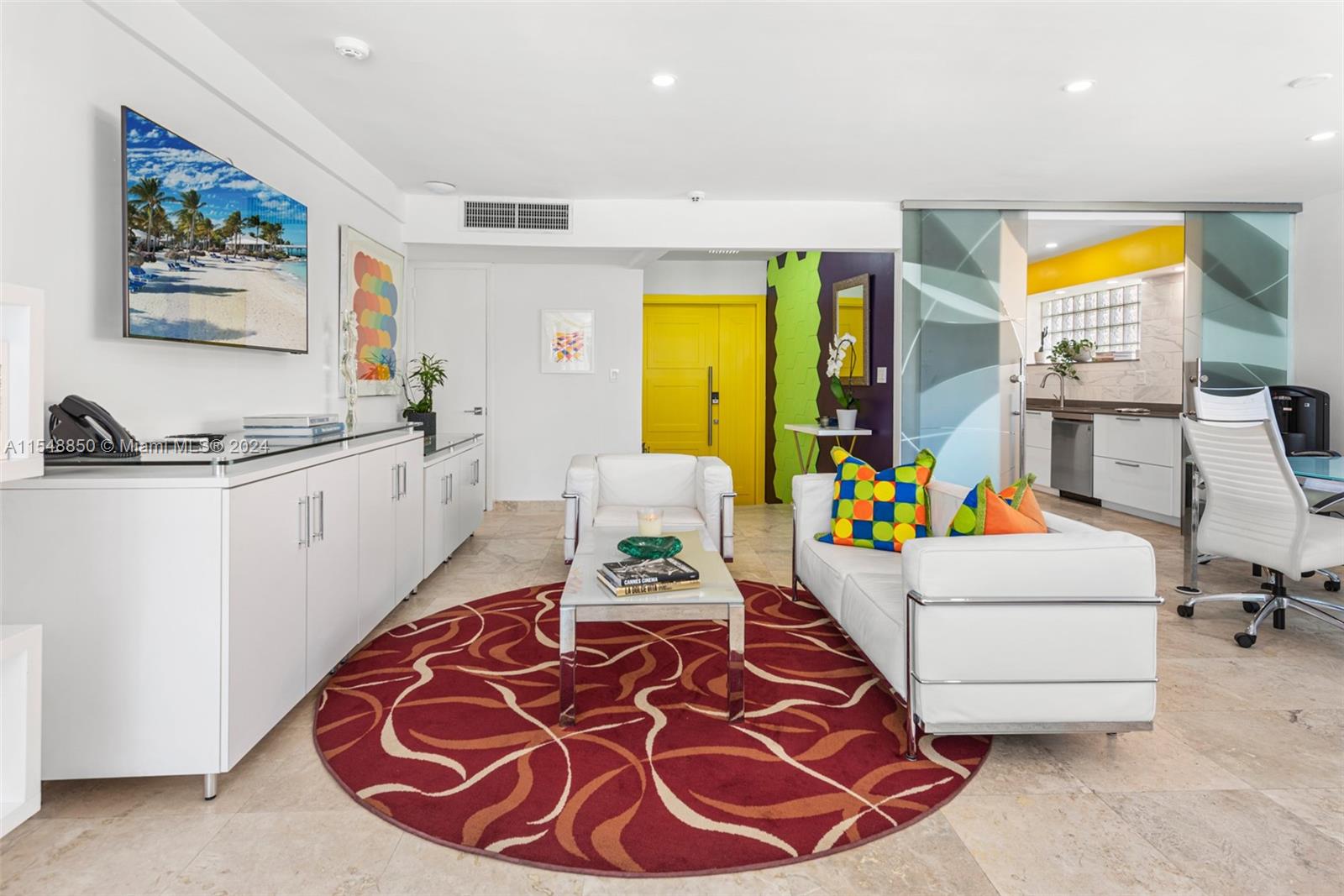 5301 Alton Road Miami Beach, FL 33140 - Photo 12 of 28 a living room with furniture and a flat screen tv