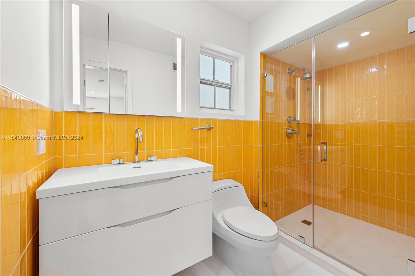 5301 Alton Road Miami Beach, FL 33140 - Photo 15 of 28 a bathroom with a sink a toilet and shower