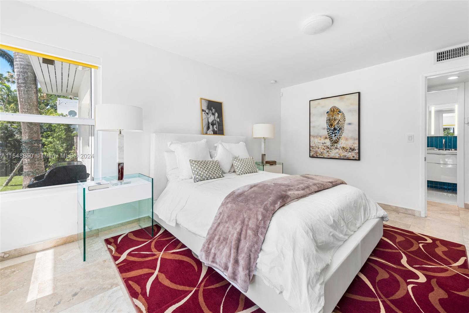 5301 Alton Road Miami Beach, FL 33140 - Photo 20 of 28 a bedroom with a large bed and a window