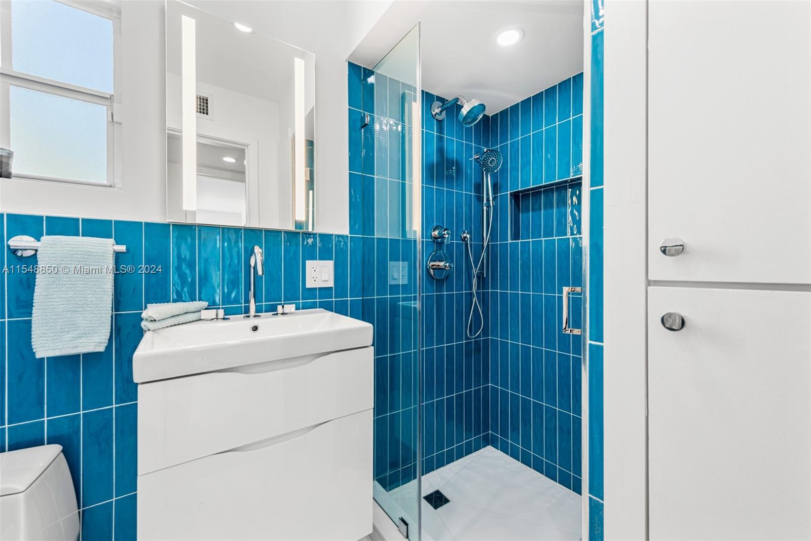 5301 Alton Road Miami Beach, FL 33140 - Photo 21 of 28 a bathroom with a shower toilet and sink