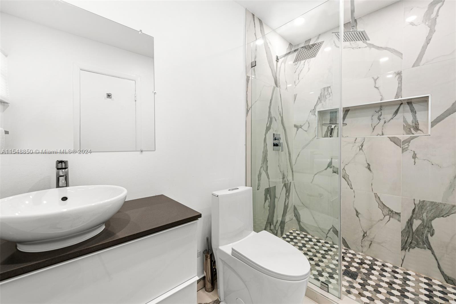 5301 Alton Road Miami Beach, FL 33140 - Photo 23 of 28 a bathroom with a sink toilet and shower