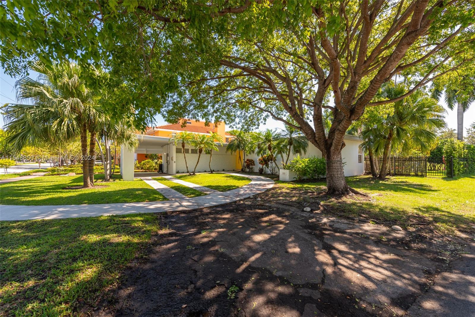 5301 Alton Road Miami Beach, FL 33140 - Photo 25 of 28 a view of a swimming pool with an outdoor space and seating area