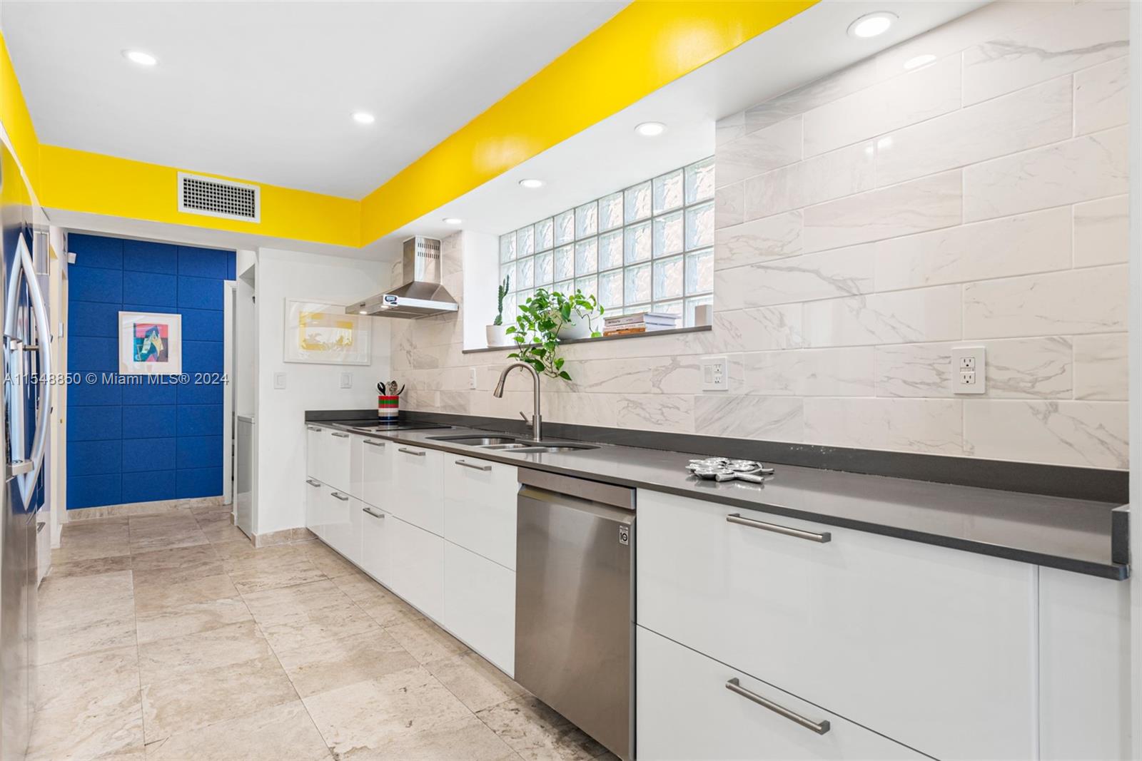 5301 Alton Road Miami Beach, FL 33140 - Photo 8 of 28 a kitchen with stainless steel appliances granite countertop a sink and cabinets