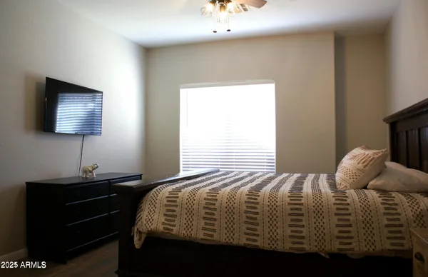 a bedroom with a bed and a flat screen tv