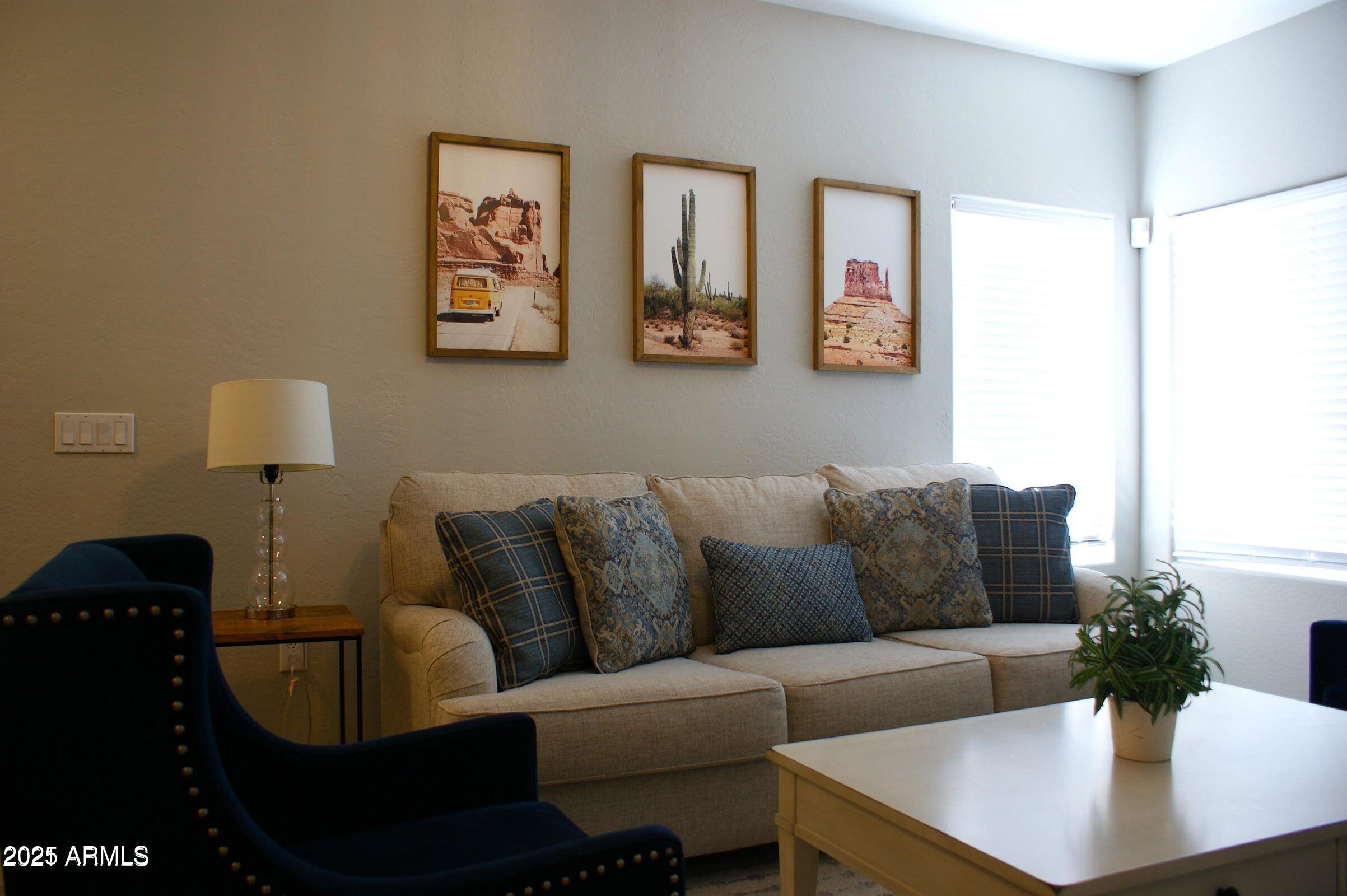 525 North Miller Road, Unit 145 Scottsdale, AZ 85257 - Photo 9 of 9 a living room with furniture and a lamp