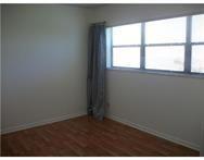 2311 South Cypress Bend Drive, Unit 416 Pompano Beach, FL 33069 - Photo 13 of 16 an empty room with a window