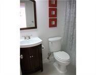 2311 South Cypress Bend Drive, Unit 416 Pompano Beach, FL 33069 - Photo 14 of 16 a bathroom with a toilet a sink and mirror
