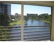 2311 South Cypress Bend Drive, Unit 416 Pompano Beach, FL 33069 - Photo 16 of 16 a view of a lake from a window