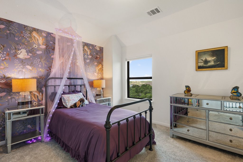 1221 Siena Sunset Road Leander, TX 78641 - Photo 27 of 39 Spacious room featuring a single window, white walls, and a patterned accent wall