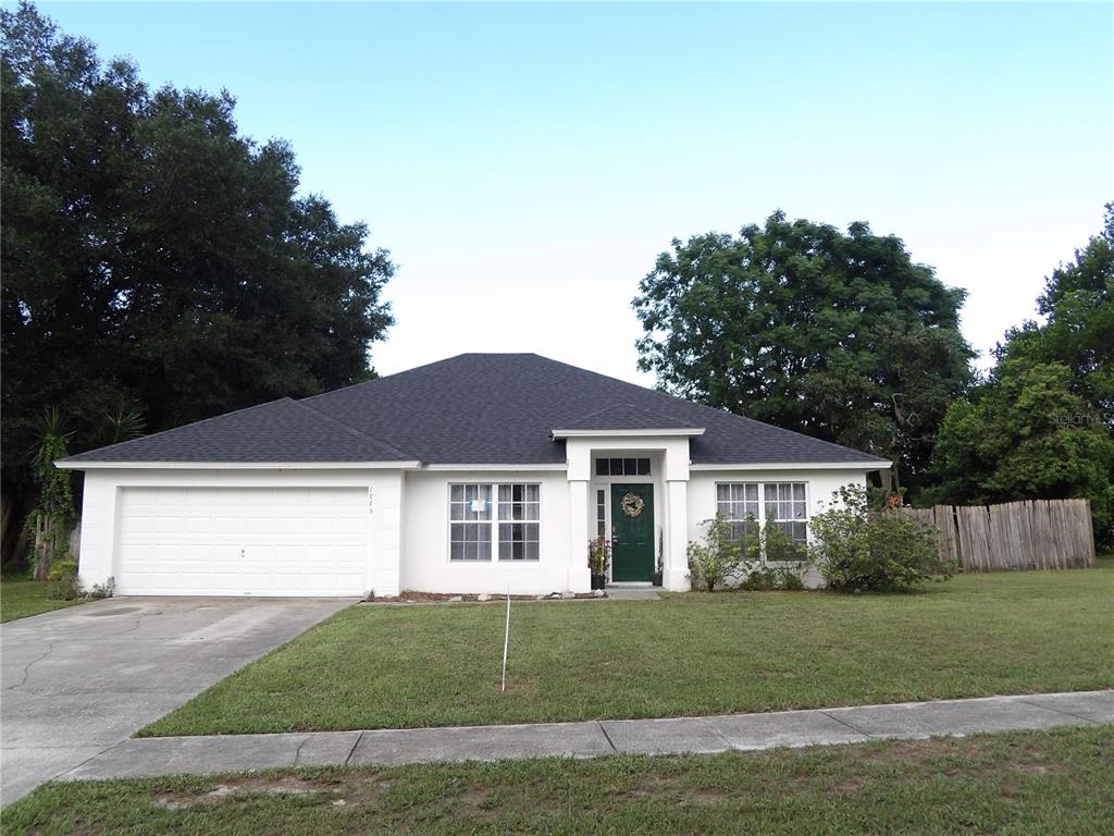 1775 Concert Road Deltona, FL 32738 - Photo 1 of 1 a front view of a house with a garden