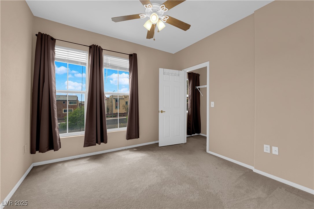 10550 West Alexander Road, Unit 2233 Las Vegas, NV 89129 - Photo 22 of 35 Carpeted empty room featuring ceiling fan and baseboards