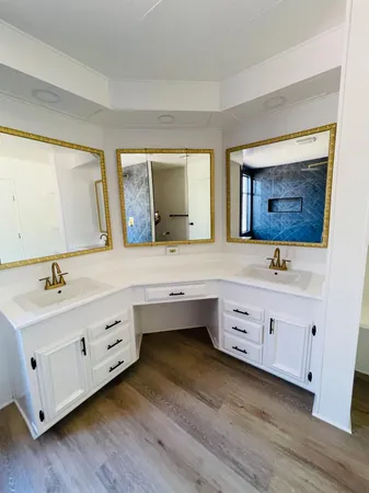 a bathroom with double vanity sink a mirror and a bathtub
