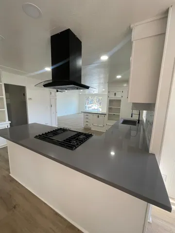 a kitchen with stainless steel appliances a stove a microwave a sink and a refrigerator