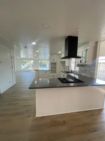 a large kitchen with a large counter top appliances and cabinets