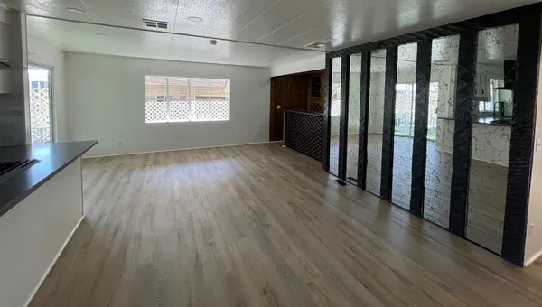 wooden floor in an empty room with a window