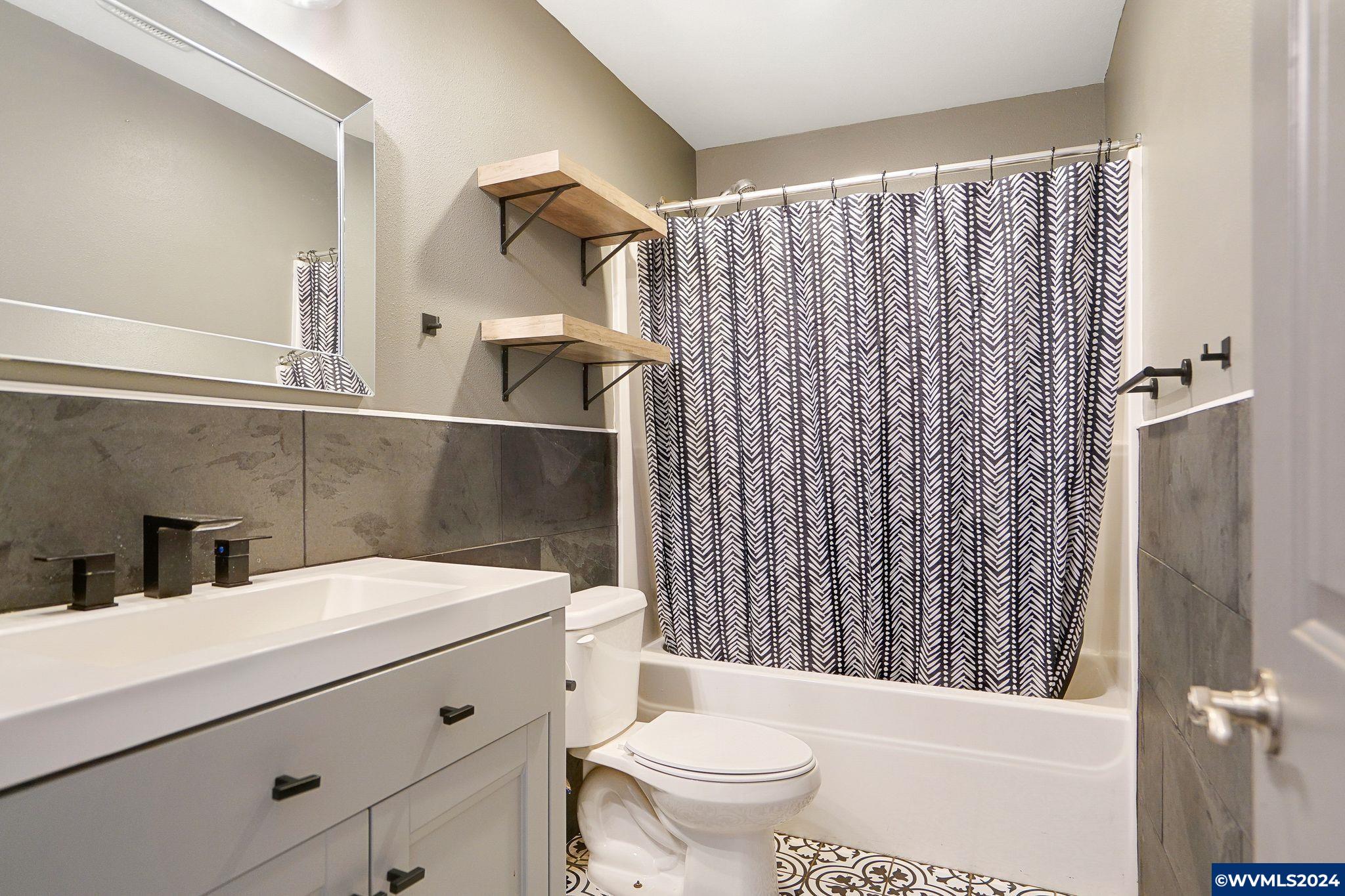16480 Oakdale Road Dallas, OR 97338 - Photo 26 of 42 a bathroom with a sink a toilet and shower curtain