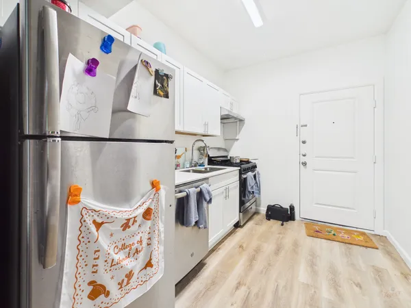 a white refrigerator freezer sitting inside of a kitchen