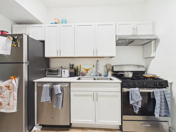 a kitchen with stainless steel appliances granite countertop a stove and a refrigerator