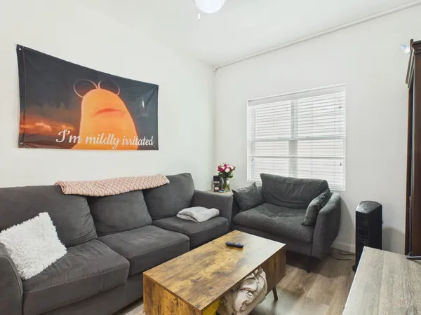 a living room with furniture a couch and a window