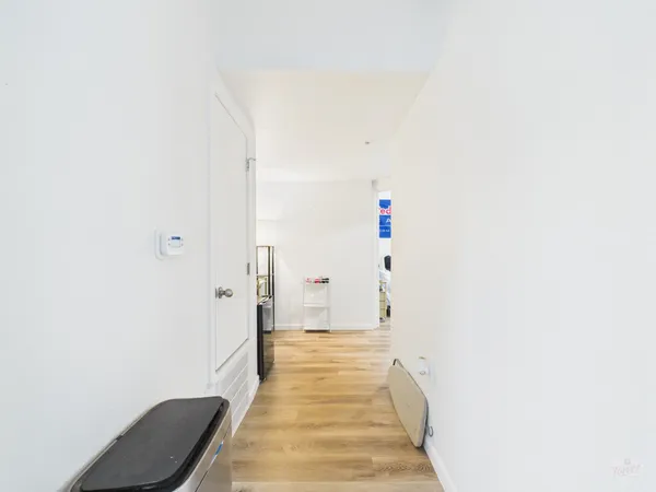 a view of a hallway with wooden floor