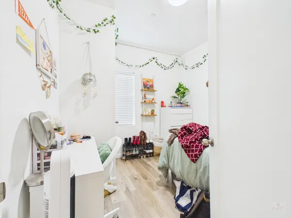 a bathroom with a sink mirror and flower pot
