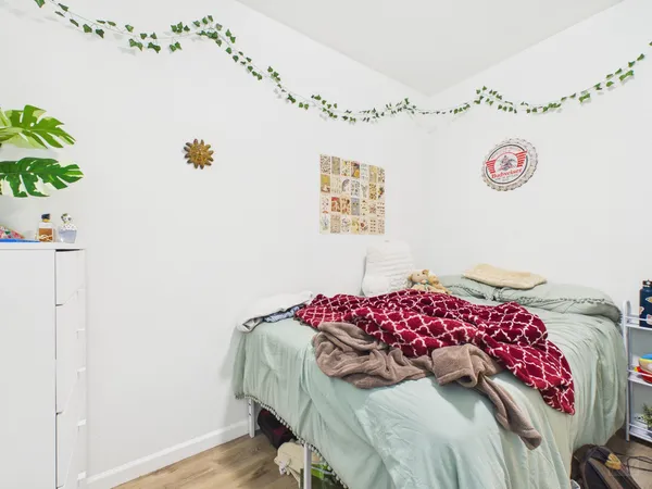a bedroom with a bed and a chandelier